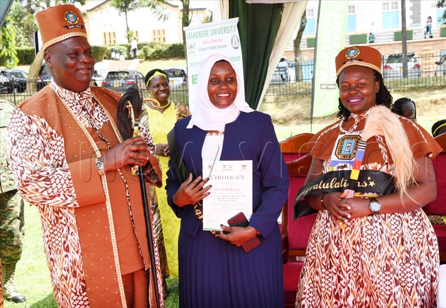 Nuruh Mbalyowere, the best student of the Science of Designing Evidence-Based Parenting Interventions Course (centre) having a photo moment with His Royal Highness, Emorimor Papa Iteso, Paul Sande Emolot (left) and Her Royal Majesty Juliet Among Emolot.