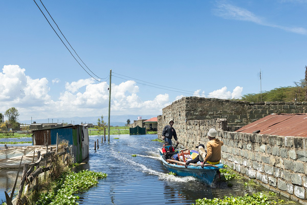 Boat operators ferry a man and his household belongings after he was forced to evacuate his flooded residence at Kihoto estate in Naivasha on November 17, 2025. Heavy rains in Kenya have caused the waters of Lake Naivasha, a hundred kilometres northwest of capital Nairobi, to flood nearby homes, displacing families. (AFP Photo)