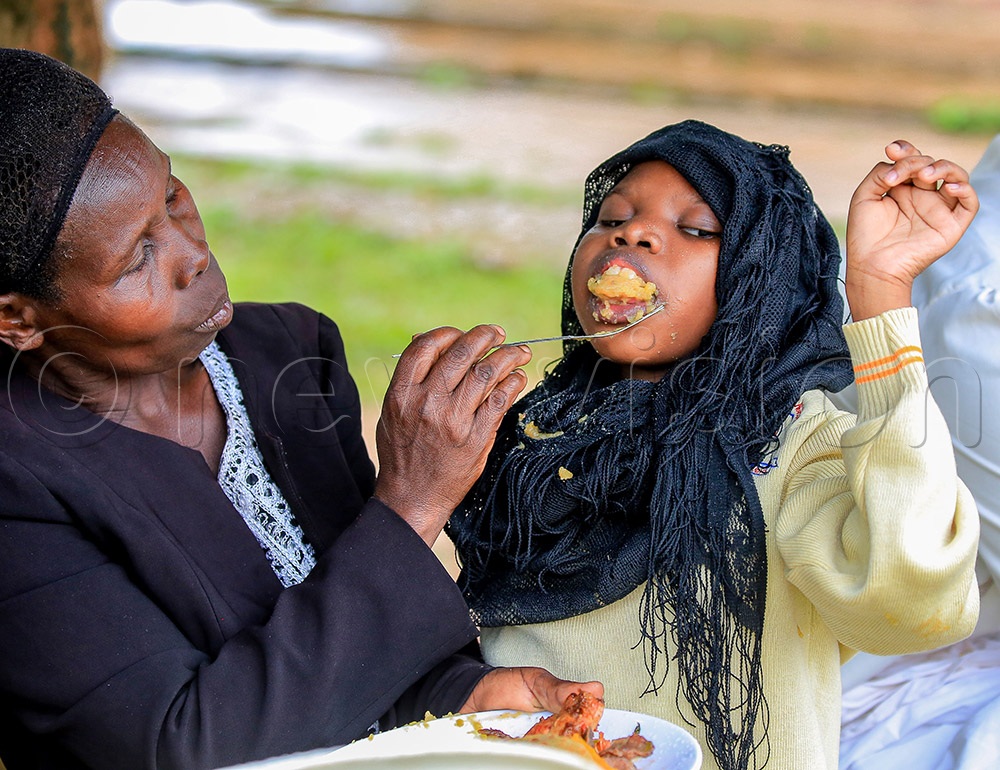 A parent feeding her child. 