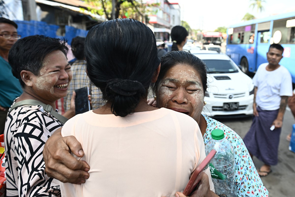 A relative (R) celebrates with a woman after she was released during an annual amnesty to mark Myanmar's independence day outside Insein prison in Yangon on January 4, 2026. 