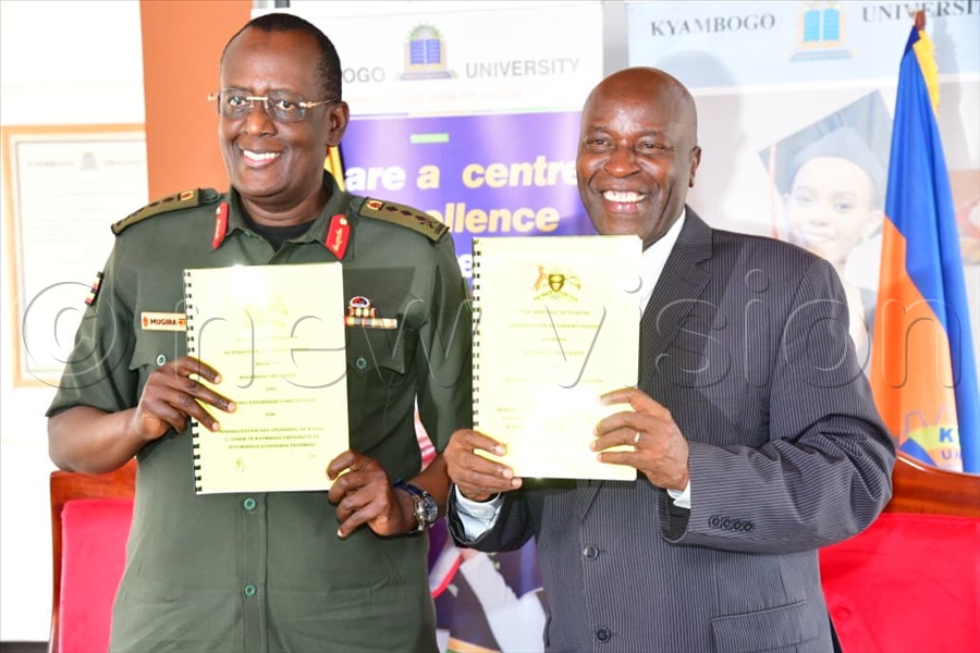 Lt. Gen James Mugira (L) on behalf of National Enterprise Corporation (NEC) and Prof. Eli Katunguka of Kyambogo University after signing a Memorandum of Understanding (MoU), where NEC will undertake the upgrading of selected roads within the university. (All Photos by Mpalanyi Ssentongo)