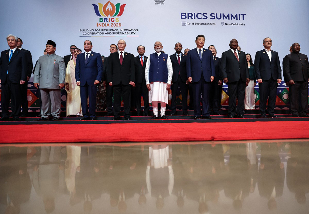 In this pool photograph distributed by the Russian state agency Sputnik, leaders of participating countries gather for a family photo during the 18th BRICS Summit in New Delhi on September 13, 2026.