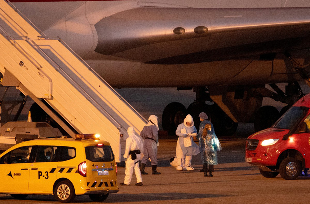 Passengers board a plane bound for US carrying passengers evacuated from the Dutch flagged hantavirus-stricken cruise ship MV Hondius at the Tenerife Sur-Reina Sofia airport on the island of Tenerife in Spain's Canary Islands on May 10, 2026. (AFP)