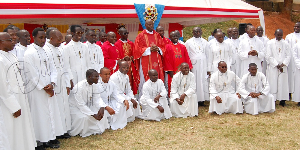 Catholic priests (wearing red chasubles) share a photo-moment with the Brothers of Christian Instruction. This was during the celebration of the 100th anniversary of the arrival in Uganda of the Brothers of Christian Instruction at Uganda Martyrs High School Lubaga on Saturday, June 6, 2026. (Photo by Mathias Mazinga)