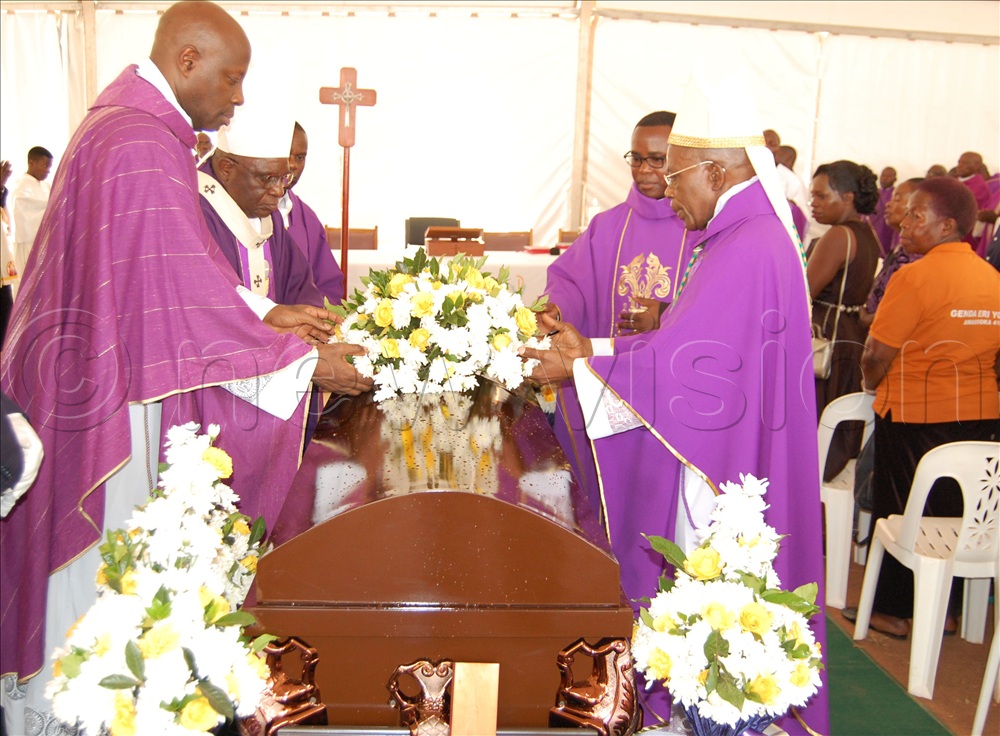 Cstholic prelates including Archbishop Dr. Augustine Kasujja (fore-right), Msgr. Rogers Kabuye Mukasa (fore-left) and archbishop Paul Semogerere (second-left) laying a wreath on the casket containing the remains of Fr. John Bosco Ssebwalunnyo during the funeral mass at Kisubi Minor Semnary, on Entebbe Road, in Wakiso district on Wednesday, August 2,  2026. 