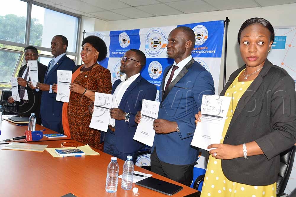 (L-R) Joseph Katregga, the legal officer Justice Access Point, executive director of African Centre for Treatment and Rehabilitation of Torture Victims (ACTV) Samuel Nsububa, chairperson of Uganda Human Rights Commission Mariam Wangadya, Jimmy Wamimbi projects coordinator Avocats San Frontiers, Keneth Kitambula, advocacy officer Human Rights Centre Uganda and Pauline Nansaba, the director investigation at the Commission, display copies of press statement after a media briefing at the agency's headquarters in Kampala. (Credit: Francis Emorut)