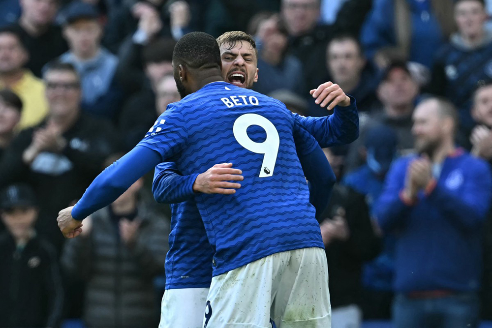 Everton's Portuguese striker #09 Beto celebrates with Everton's English midfielder #22 Kiernan Dewsbury-Hall after scoring their first goal during the English Premier League football match between Everton and Liverpool at Hill Dickinson Stadium in Liverpool, north west England on April 19, 2026. 