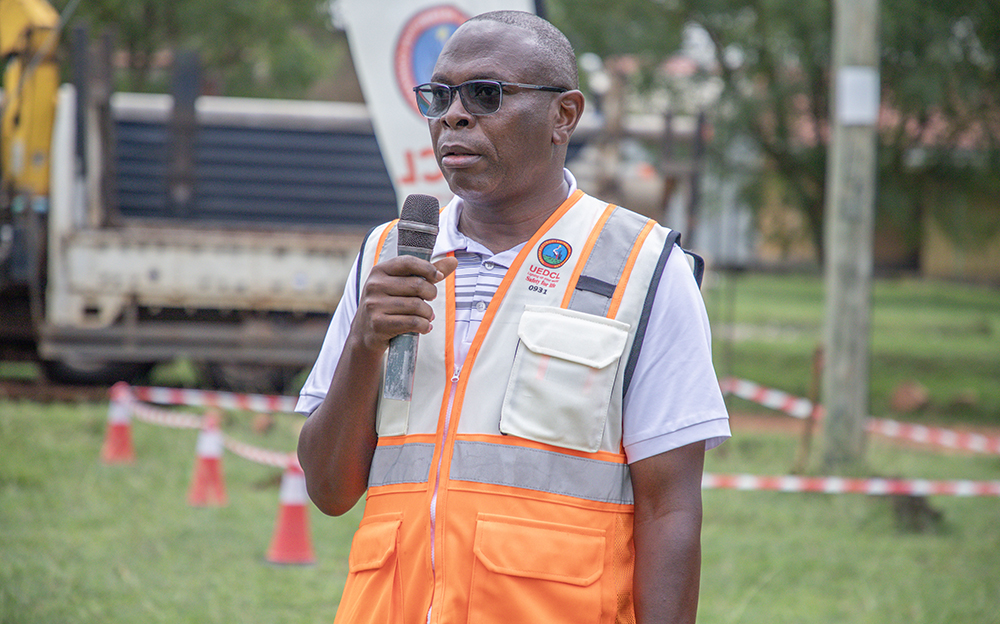 Eng. Johnson Okoch, the project manager, speaking during the ground breaking ceremony at Kasese district offices on Wednesday.