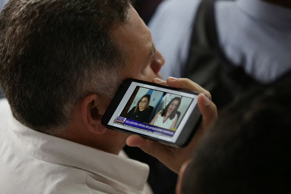 The council members of the National Electoral Council (CNE) Ana Paola Hall (President), Cossette Lopez-Osorio and Carlos Cardona (alternate council member for Marlon Ochoa), virtually read the presidential declaration of the elections held on November 30, in Tegucigalpa, Honduras on December 24, 2025. (AFP)