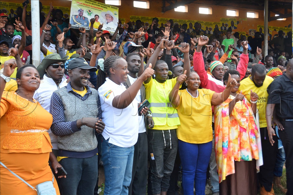 The senior presidential adavisor on agriculture and rural development Peace Rugambwa ( in blue jeans ) pose for a group photo with Ghetto youth after a campaign meeting at Kabale Central Stadium in Kabale district on Sunday November 9, 2025.