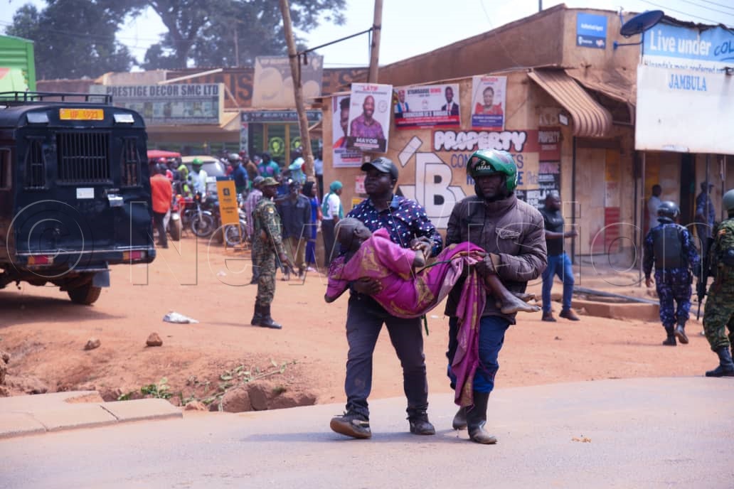 Boda boda men carrying an injured person during Kyagulanyi's campaign rally. (Credit: Ponsiano Nsimbi) 