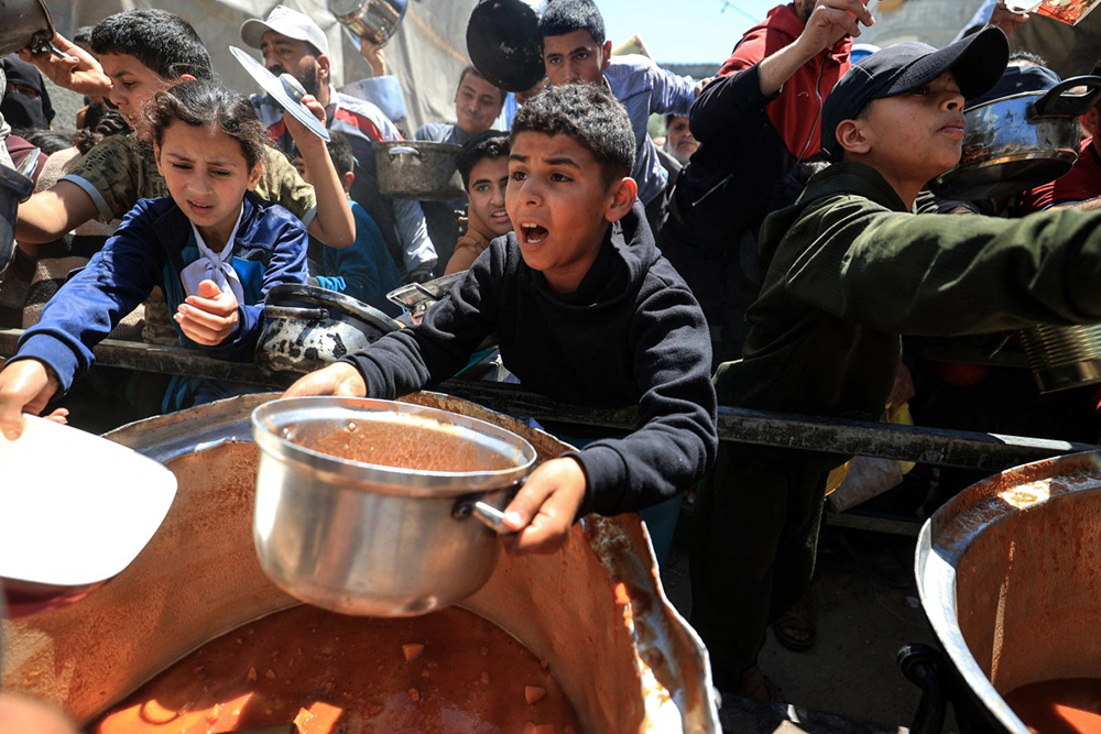 An ambulance makes its way to the site of an Israeli strike on a police vehicle in Khan Yunis, in the southern Gaza Strip on April 24, 2026. (AFP)