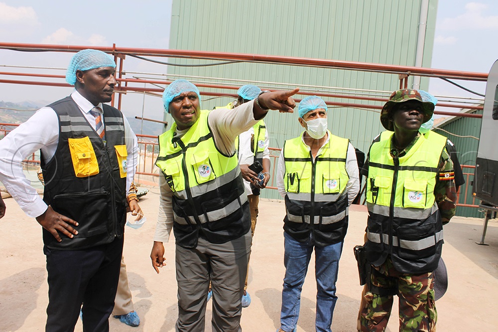Nelson Tugume (Centre), Chief Executive Officer of Inspire Africa Coffee Park, briefs State Minister Jonard Asiimwe Akiiki (Left) and other guests on the products manufactured at the facility, alongside members of his team. (Photo by Abdulkarim Ssengendo)