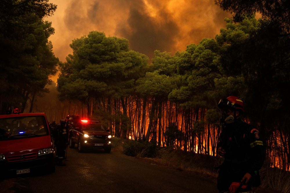Greek firefighters try to extinguish a wildfire in the area of Porto Germeno, some 70 kilometres (45 miles) northwest of Athens in the region of Viotia, on August 1, 2026. 