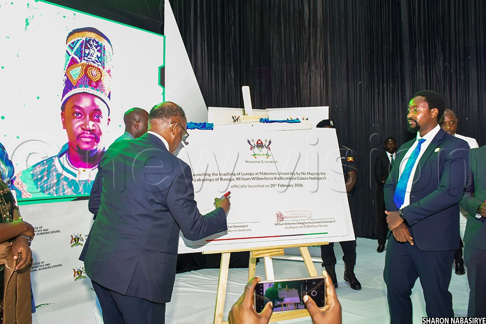 Makerere Vice Chancellor Prof. Barnabas Nawangwe signing on a dummy during the launch of Lusoga teaching at Makerere University. (Photo by Sharon Nabasirye)