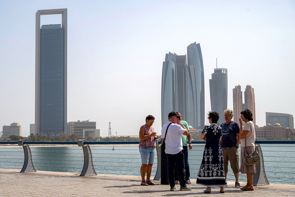 A handful of tourists near Etihad Towers in Abu Dhabi which has come under Iran's retaliatory missile and drone campaign in the Gulf. 