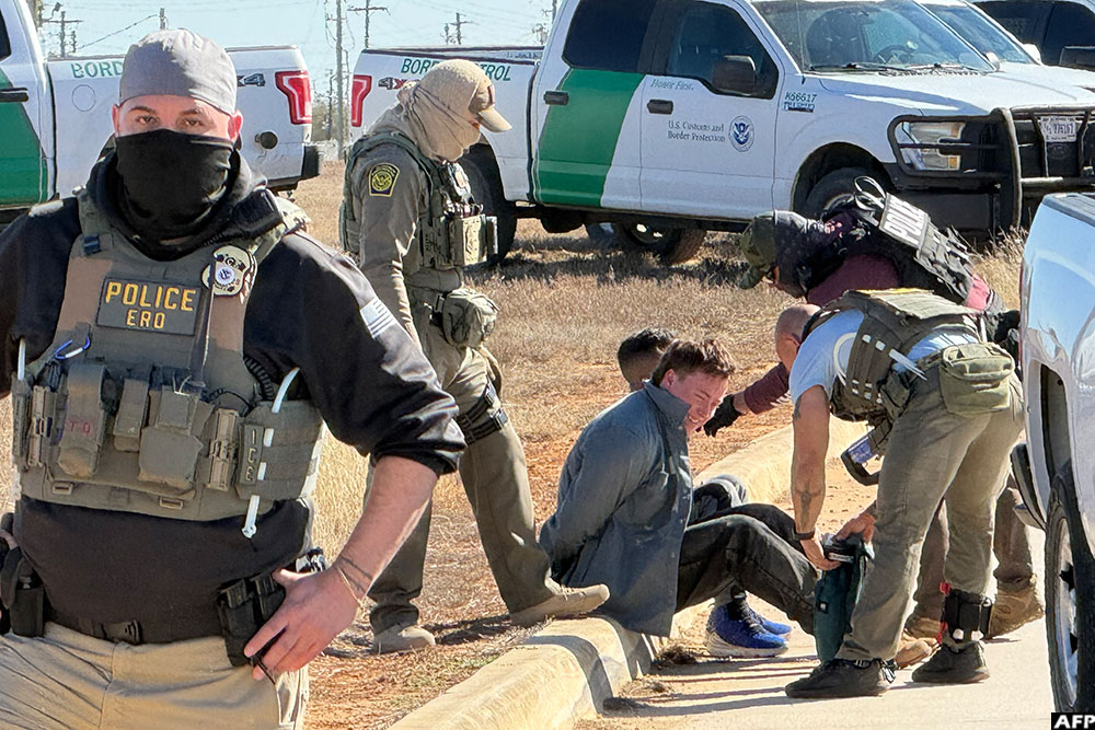 Law enforcement detains a protestor during a demonstration and vigil outside the South Texas Family Residential Centre in Dilley, Texas, on January 28, 2026