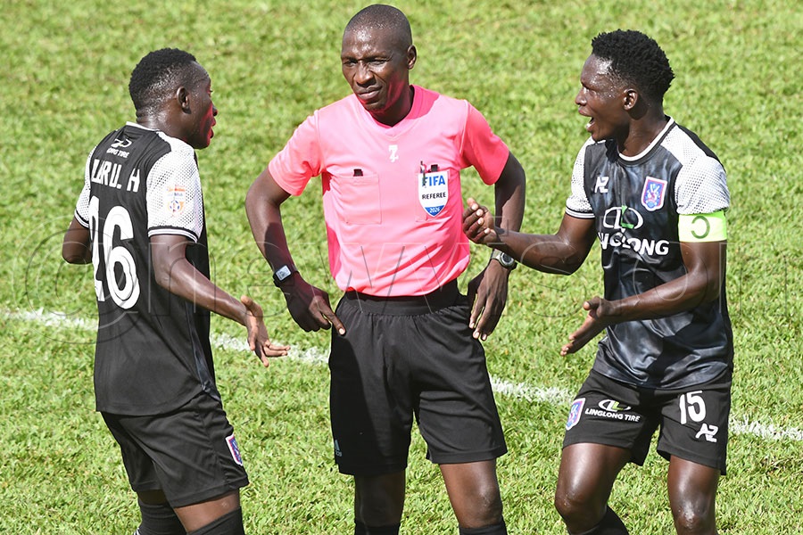 SC Villa's Hassan Mubiru (left) and David Owori (right) protest to referee William Oloya after their would be equaliser was cancelled for offside during a Uganda Premier League match at Kira Road Police ground. Photo by Michael Nsubuga