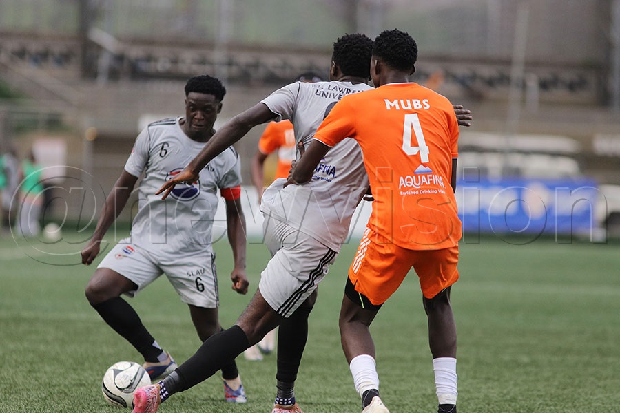 SLAU's Edrine Kalema dribbles past MUBS opponent during their game at Hamz Nakivubo War Memerial Stadium