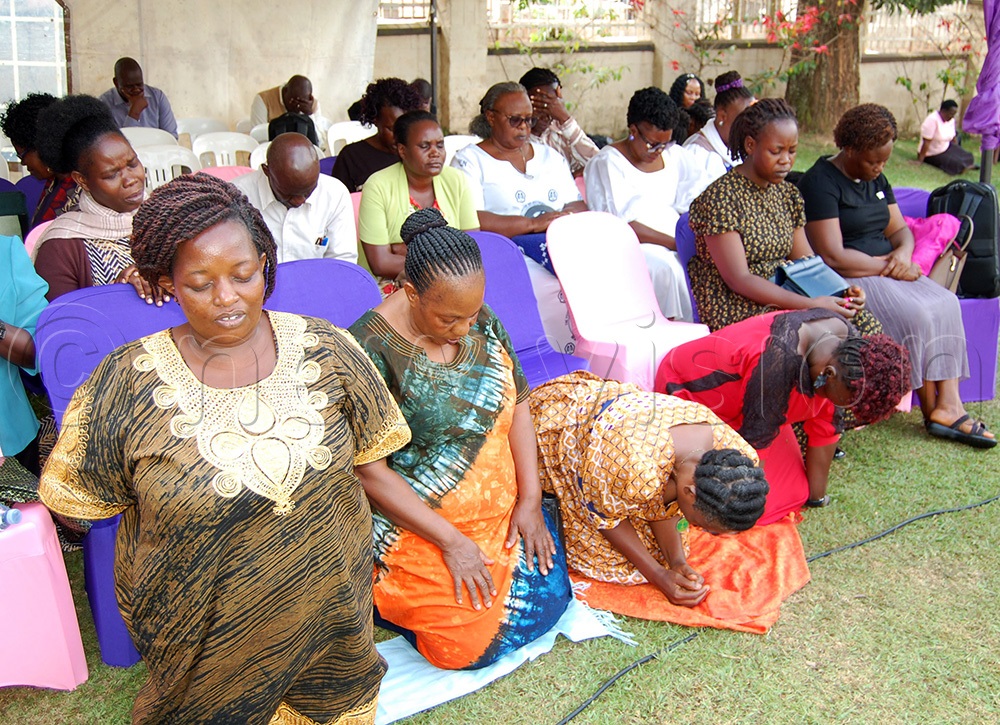  Christians in intense prayer during the service. (Photo by Mathias Mazinga)