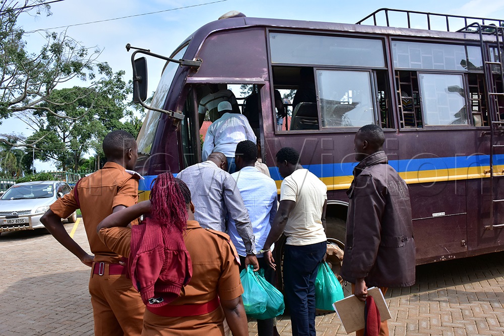 Fr Dominic Alinga (at the back) boards a Uganda Prisons Service bus. (Photo by Julius Luwemba)