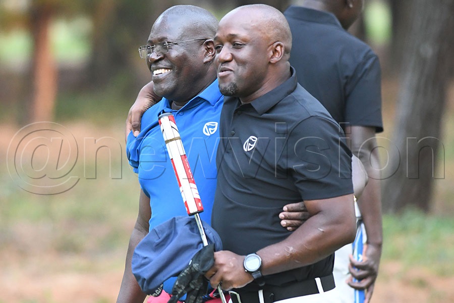 Charles Kabunga (left) is congratulated by his 'pageboy' Picole Lukyamuzi after the finals of the Stanbic Entebbe Match Play final at the Entebbe Club course. Photo by Michael Nsubuga