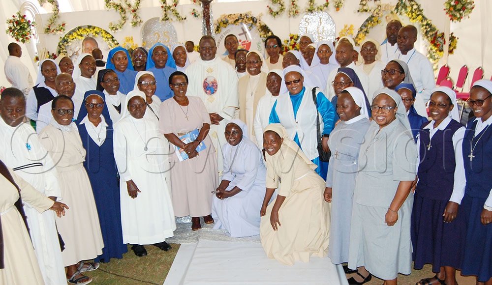 Priestly silver jubilarian Fr. Dr. Ambrose Bwangatto (wearing a white chasuble) shares a photo-moment with the Catholic religious Sisters and Brothers who graced his thanksgiving functon at St. Mbaaga's Major Seminary Ggaba on Friday, August 22. (Photo by Mathias Mazinga)