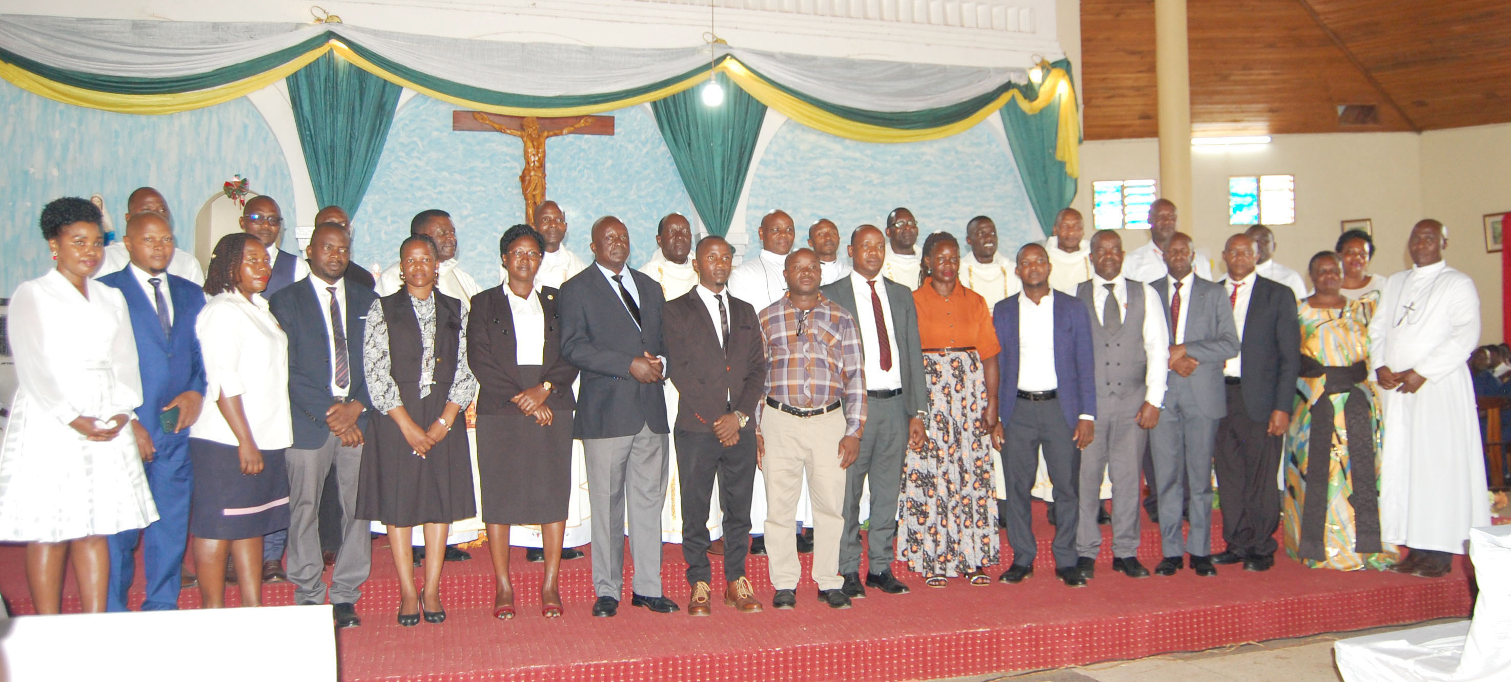 SHACK'S staff members sharing a photo moment with the priests after Mass. (Photo by Mathias Mazinga)