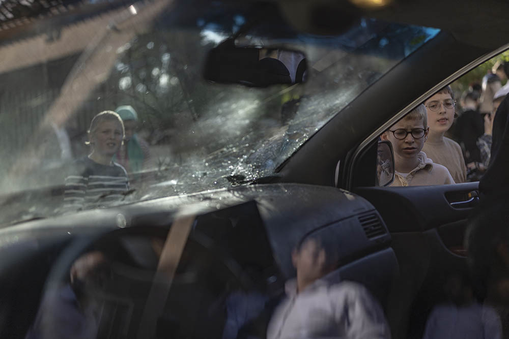 People gather at the site of an Iranian strike in Bnei-Brak, just east of the Israeli coastal city of Tel Aviv on March 8, 2026. (Credit: AFP)