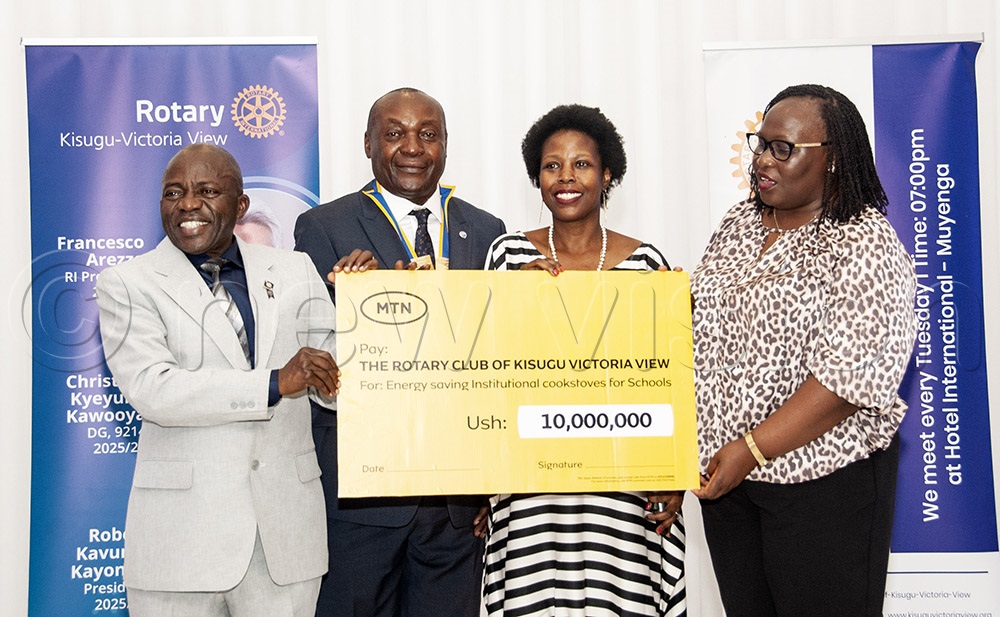 Enid Edroma (1st right), the MTN Company Secretary, hands over a dummy cheque of sh10m which will help with the Rotary Club of Kisugu-Victoria View's project to distribute energy saving stoves to schools in Kampala and Eastern Uganda. (Photo by Kalungi Kabuye)