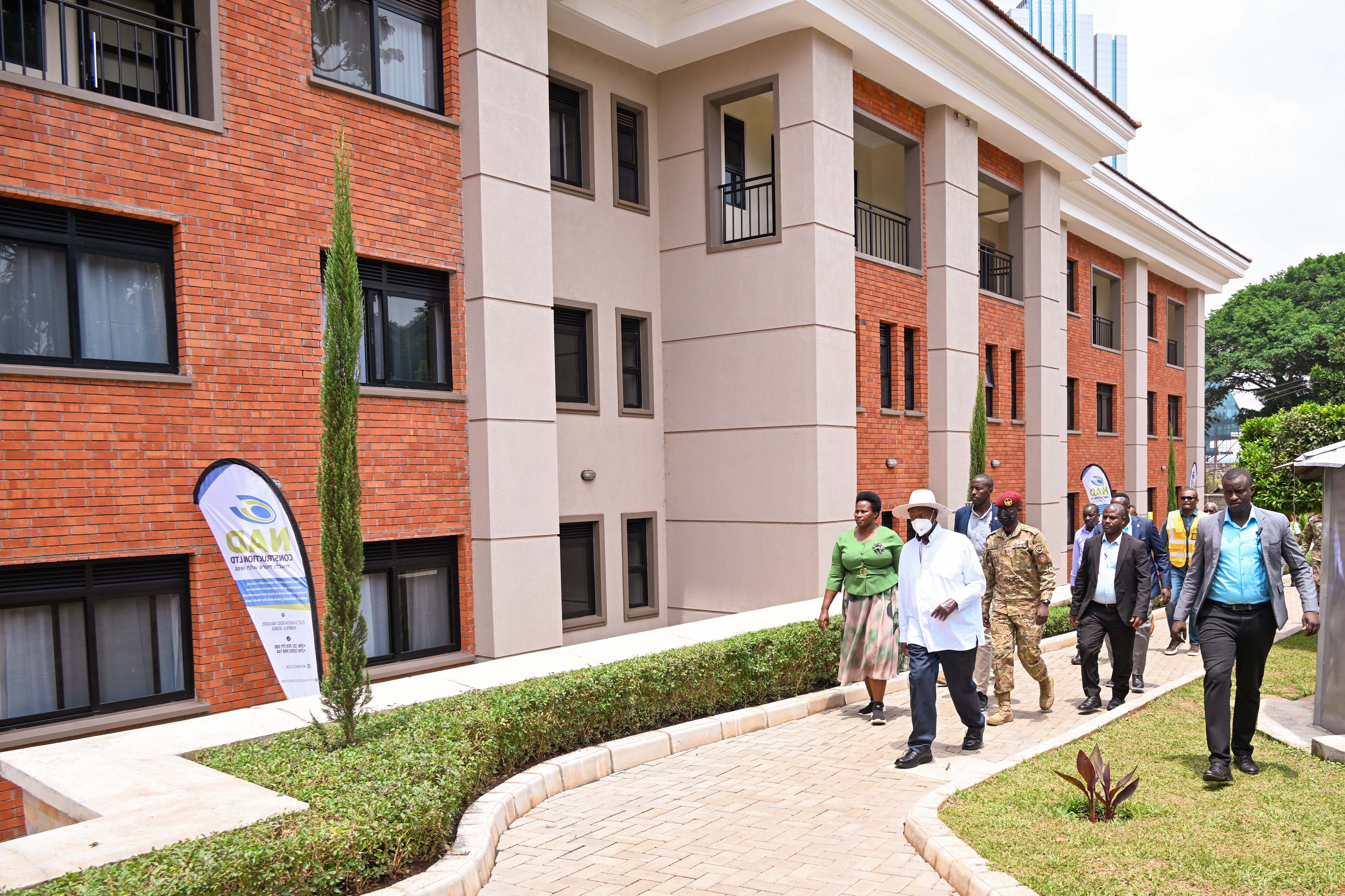 State House Comptroller Jane Barekye (L) takes President Museveni on a guided tour the SFC detach dormitories during its commissioning at Nakasero on Wednesday. 