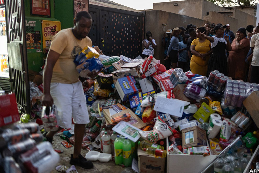 Goods from a spaza shop (convenience store) lay on the pavement outside the shop after it was raided following clashes between local residents and foreign nationals in Soweto on October 8, 2026.