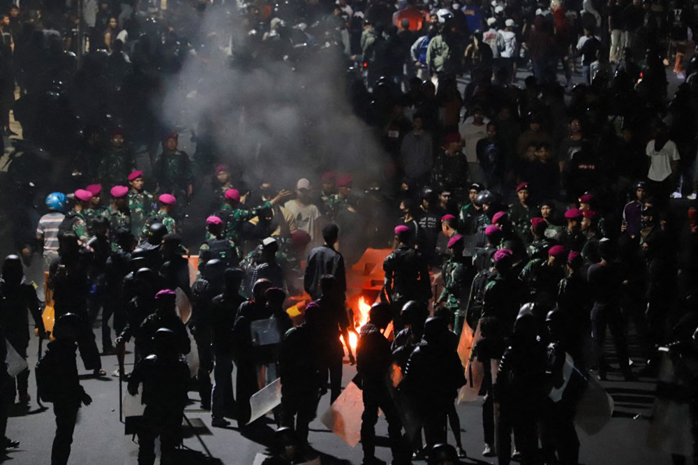 Clashes between protesters and security forces continue as public anger over a lavish housing allowance for lawmakers fueled demonstrations since Monday in Surabaya, Indonesia, on August 30, 2025. Riot police fired water cannons and tear gas to disperse thousands of stone-throwing protesters gathered near the nation's parliament building. The unrest was triggered by a monthly housing stipend of 50 million Indonesian rupiah (approximately $3,075) granted to members of parliament, an amount nearly ten times the minimum wage in Jakarta.
