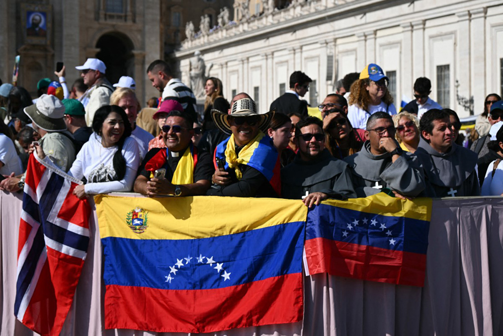 Faithful stand with Venezuela's flags as they wait for Pope Leo XIV tour after a mass for the canonization of seven new Saints at St Peter's square in The Vatican, on October 19, 2025. (Photo by Filippo MONTEFORTE / AFP