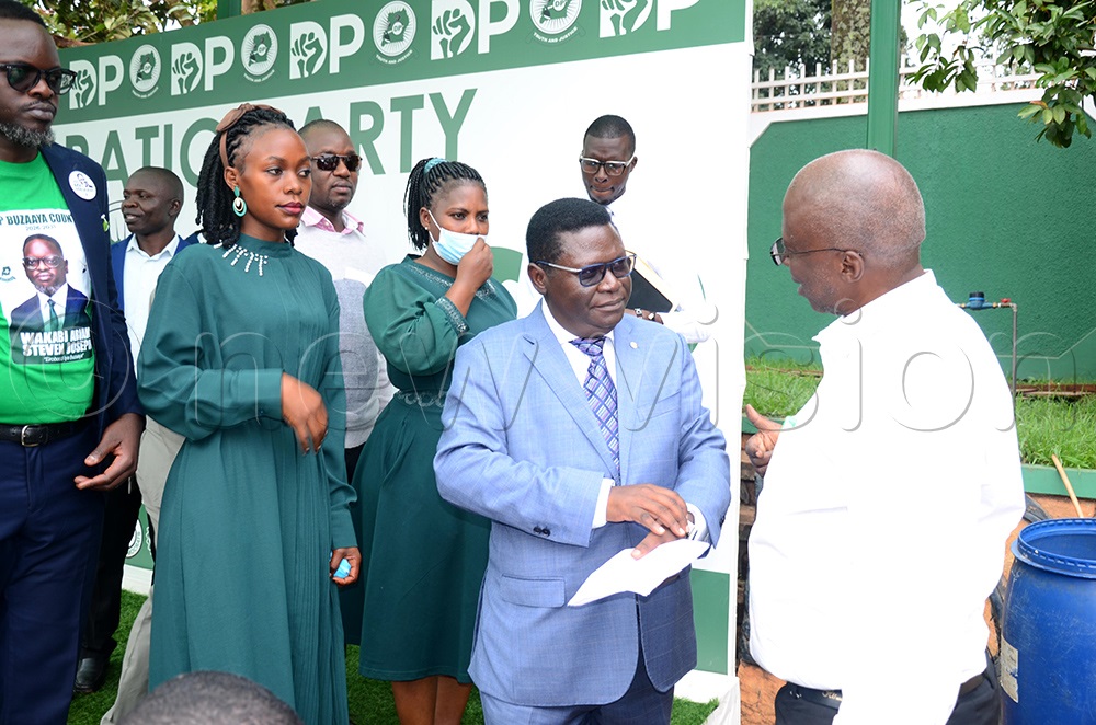DP president general, Nobert Mao speaking to DP electoral management committee chairperson Keneddy Mutenyo after addressing journalists at Balintuma (Photo by Isaac Nuwagaba)