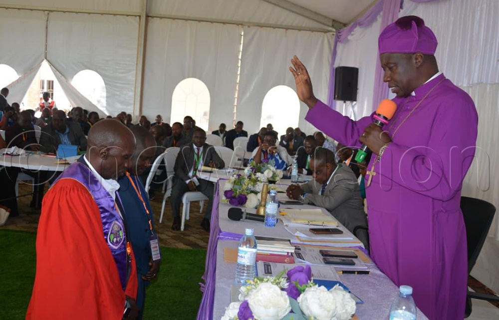 The Bishop praying for those who were elected. (Credit: Bruno Mugizi)