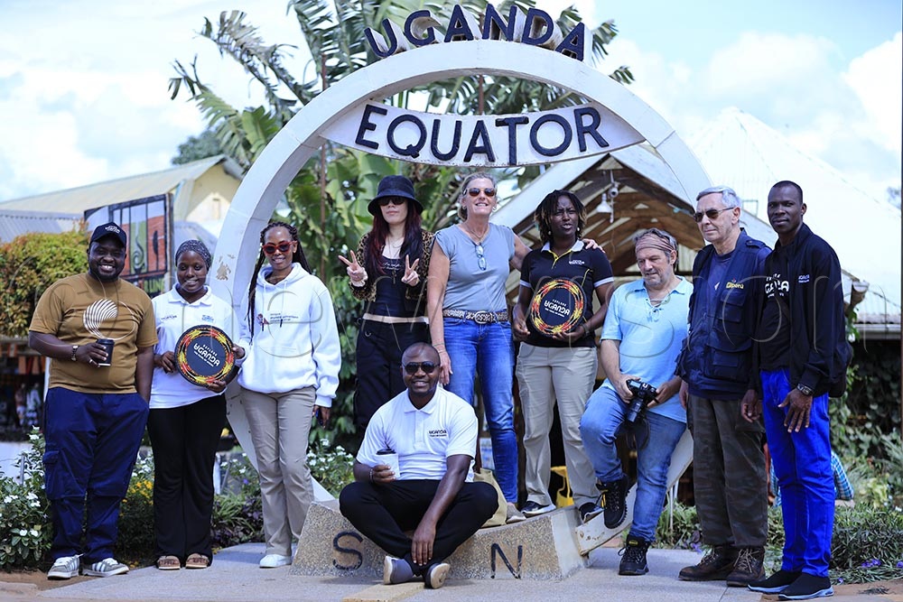 Part of the hosted media enroute Western Uganda for wildlife immersion, having a stop-over at the Kayabwe equator monument. (Credit: Julius Luwemba)