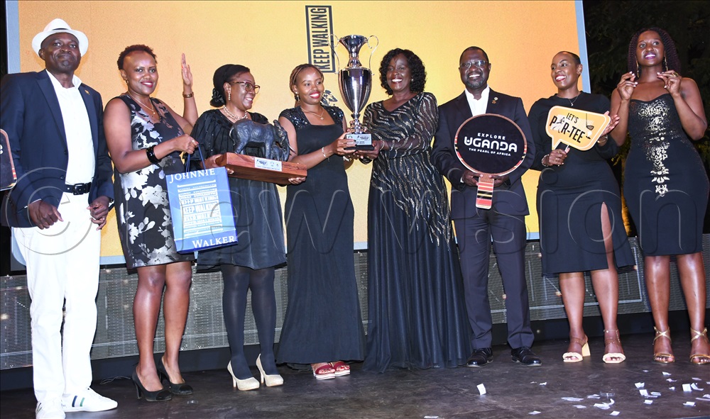 Mercy Nyanchama (center) receives her prizes from Josephine Njoroge (2nd left) the finance and strategy director at Uganda Breweries Limited, Maxi Byenkya, ULGU president Rita Apell as UGU president Jackson Were (right) looks on after the Johnnie Walker Uganda Ladies Open Golf Championship at the Lugazi Hills Golf and Country Club, August 30, 2025.