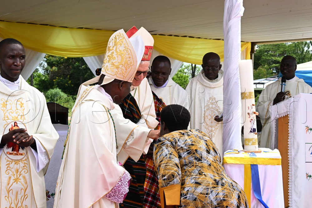Vice President Jessica Alupo tapping the blessings of Moroto Catholic Bishop shortly after ordination of Deacon Christopher Olupot in Kumi district on Easter Monday. (Credit by Delux Emmy Alomu)
