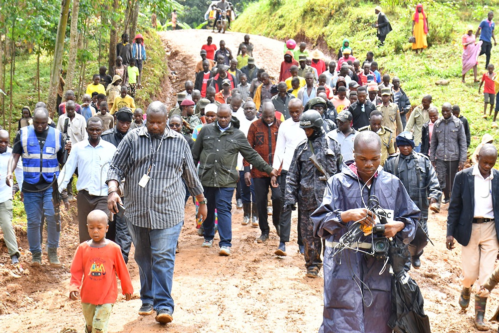 The Minister of Local Government Balaam Barugahara (C) joined by MPs, Ministry and Mbale district officials in inspecting the Bukingara-Budwale 6km road stretch on July 18th. Its alleged that sh300m was spent on construction of the road but the work done was shoddy. (Credit: Donald Kiirya)