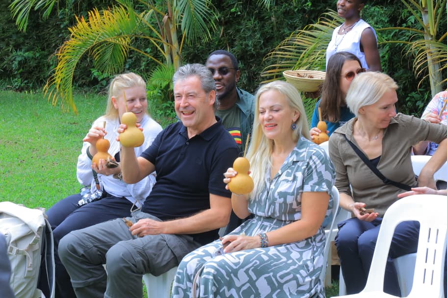 The Germany tourists test Bushera at a head of a dinner at Nderere Cultural Centre in Kampala. (Courtesy)