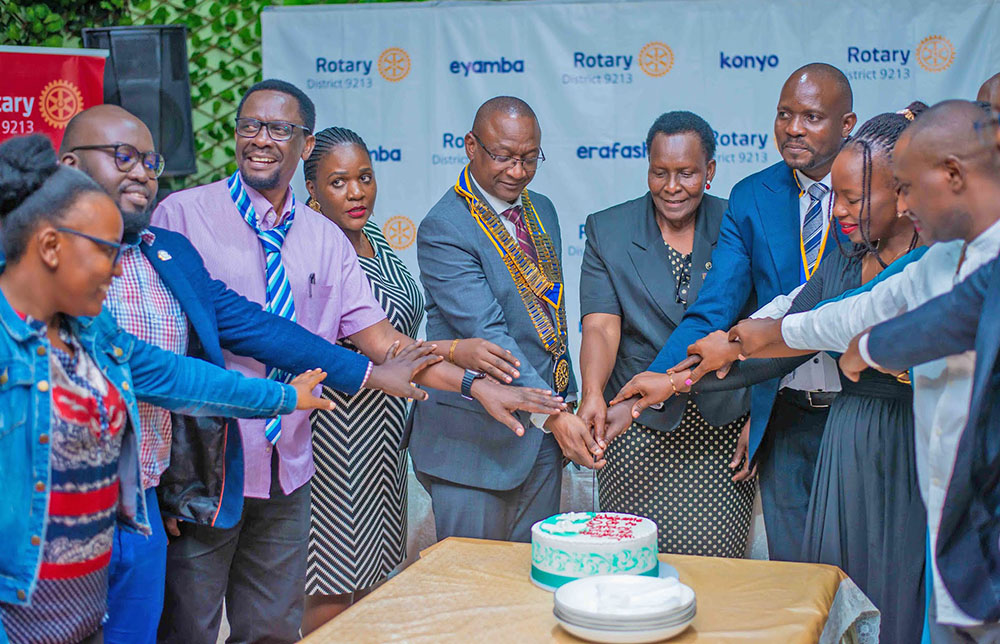 The District Governor (DG) of District 9213, Geoffrey Kitakule (centre) joined by members of the Rotary Club of Kanyanya in cutting a cake during an event held at Greenfield Gardens, Kanyanya.(Courtesy Photos) 