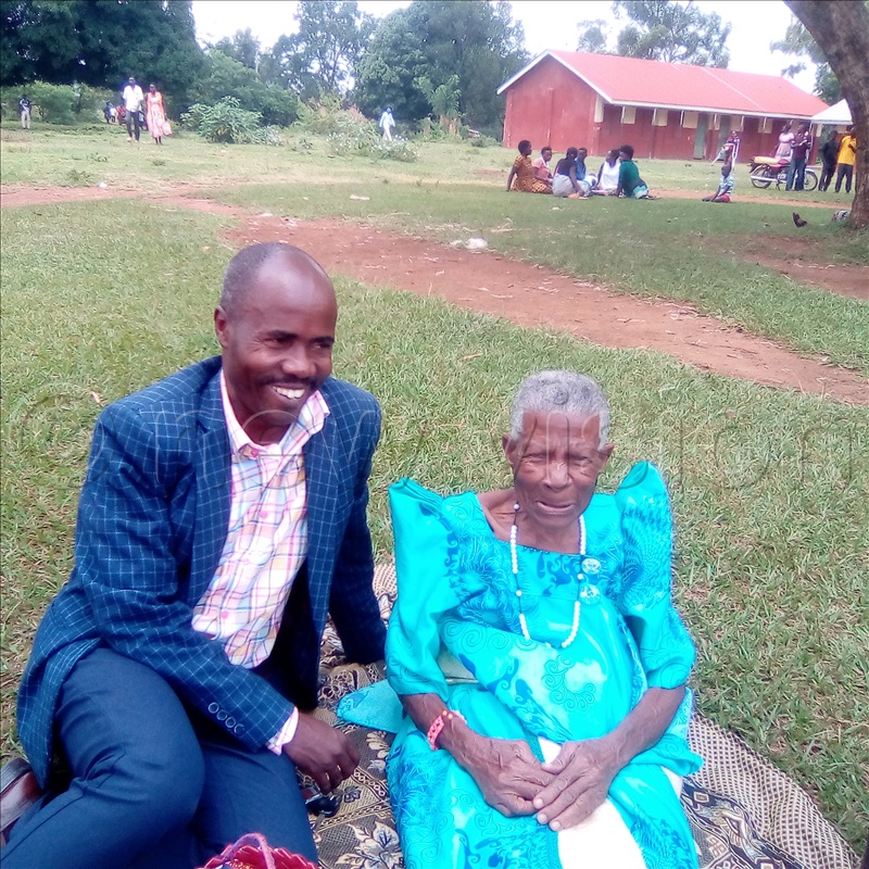 A 105-year-old woman sharing a light moment with Julius Ahura, the former parliamentary contestant for Buhaguzu East in the recently concluded primary elections.