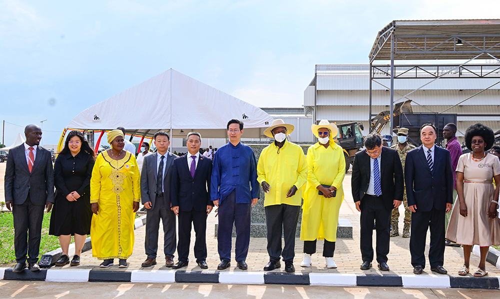 President Museveni accompanied by First Lady Maama Janet Museveni pose for a photo with Chinese investors during the flag off ceremony. 