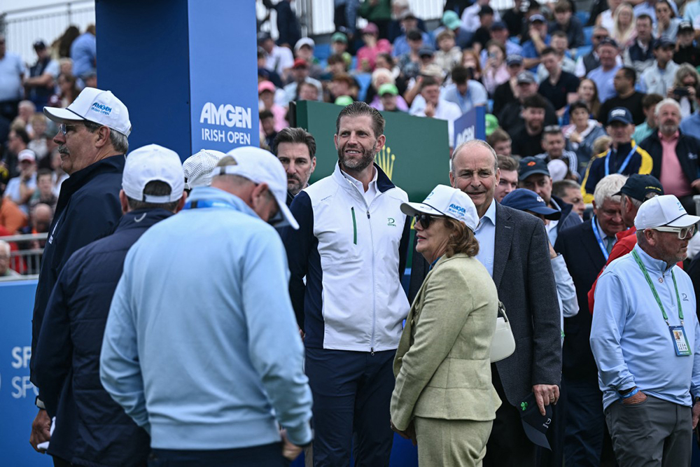 Eric Trump (C), the son of US President Donald Trump, stands with Ireland's Prime Minister Micheal Martin (centre R) as they attend the final round of the Irish Open golf tournament at the Trump International Golf Links & Hotel in Doonbeg, western Ireland on September 13, 2026. 