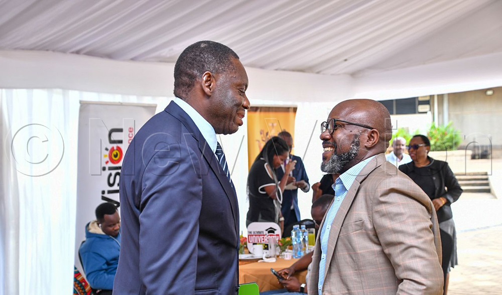 Michael Atingi-Ego (left) , Governor of the Bank of Uganda, with Vision Group CEO, Don Wanyama (Right). (Credit: Miriam Namutebi)
