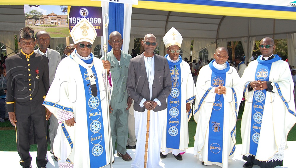 Pioneer alumni John Chrysostom Sserwadda (holding a walking stick) and his contemporaries share a photo moment with the Catholic prelates. (Photo by Mathias Mazinga)