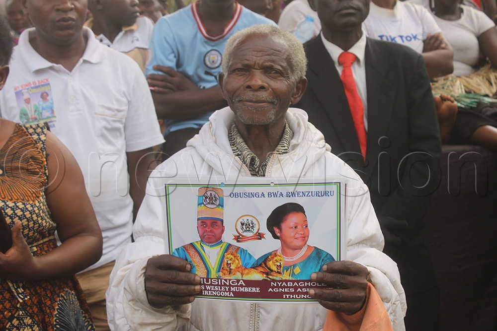 In attendance at Rwenzori Square in Kasese Municipality was an old man expressing his joy for the king's return by carrying a portrait of the Omusinga and his wife. (Credit: Samuel Amanyire)