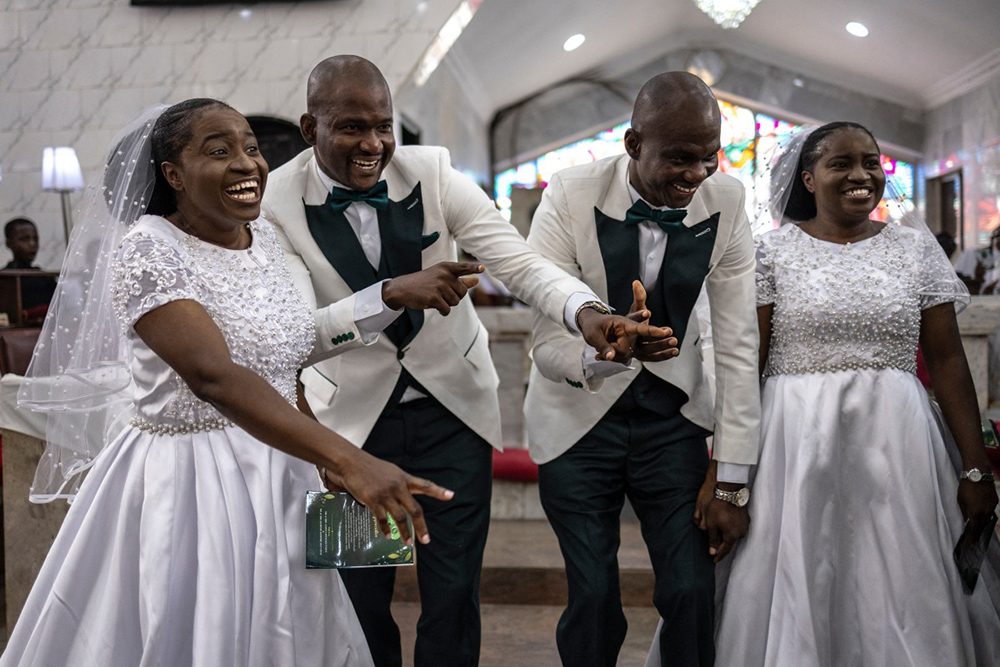Grooms and brides dance during their wedding ceremony at the Bishop Akinyele Memorial Anglican Church in Ibadan, on June 20, 2026. 