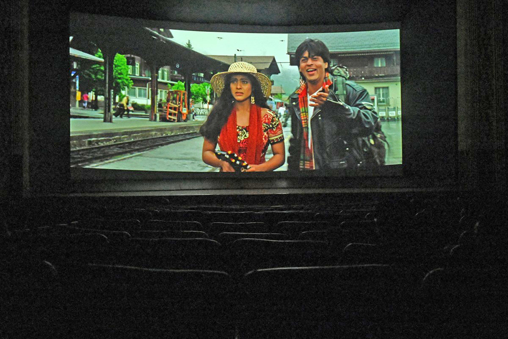 In this picture taken on October 11, 2025, an iconic scene is seen during the screening of the popular Bollywood Hindi film 'Dilwale Dulhania Le Jayenge' (The brave hearted will take the bride away) at Maratha Mandir theatre in Mumbai. (AFP)